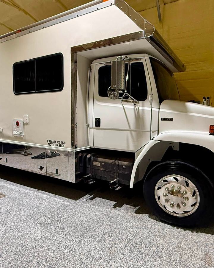 White Freightliner motorhome parked in the bay after a detail