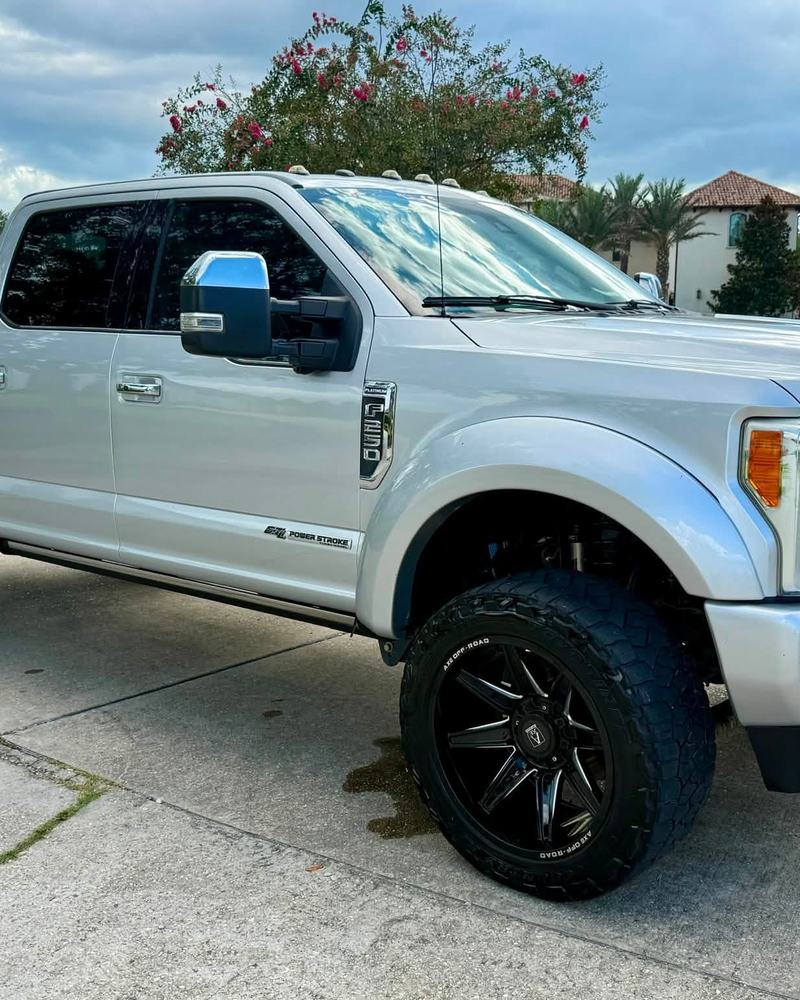 Silver lifted Ford F-250 Platinum on a driveway after a detail, chrome grille shining