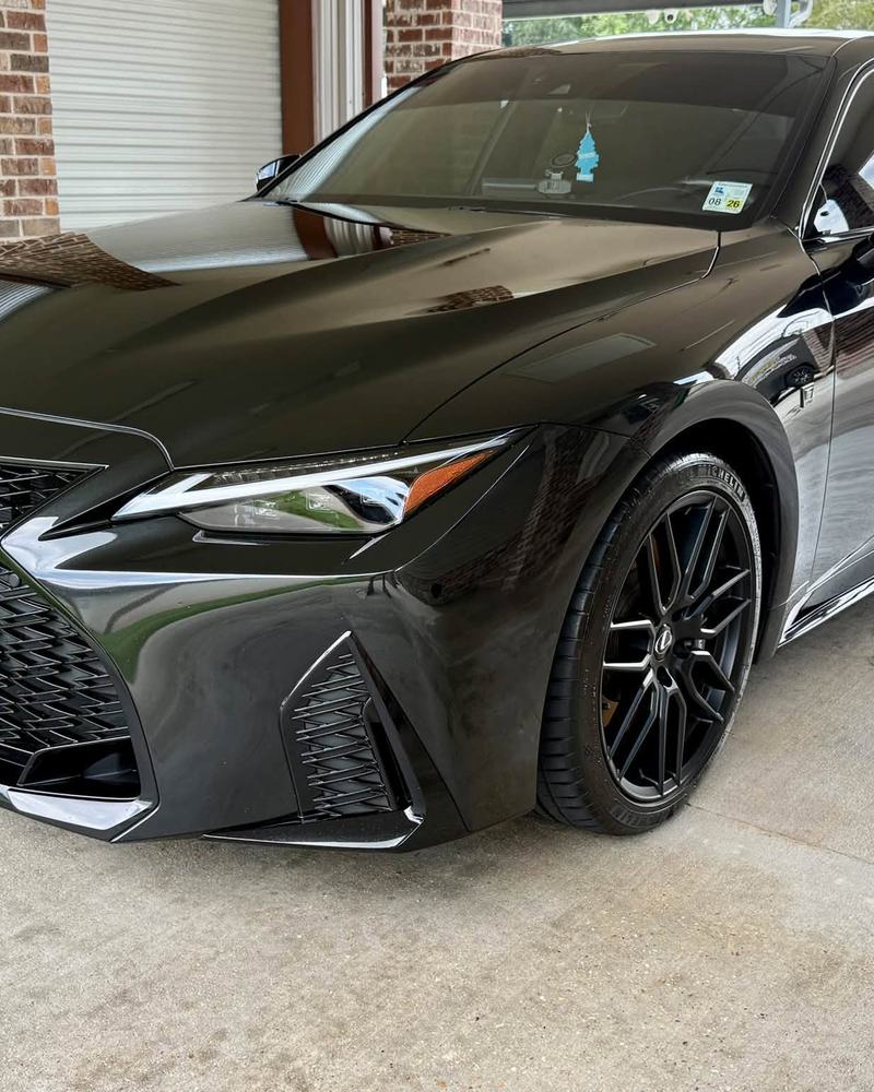 Black Lexus IS 500 under a carport after a full detail, black wheels and deep gloss paint